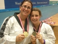 Mother and  daughter in the Tae Kwon Do medals