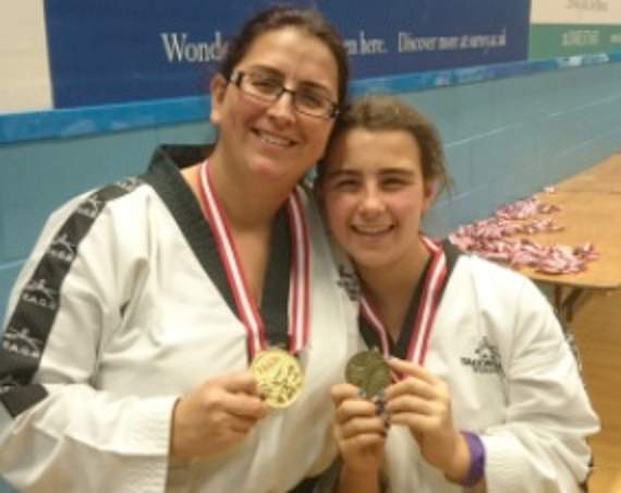 Mother and  daughter in the Tae Kwon Do medals