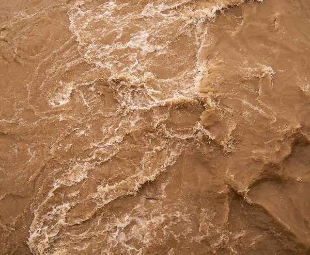 Cyclist trapped in flood water
