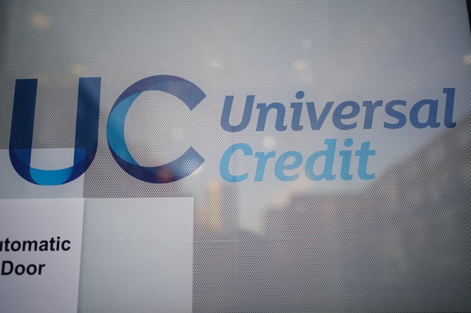 A Universal Credit sign on a door. Picture date: Wednesday October 6, 2021.