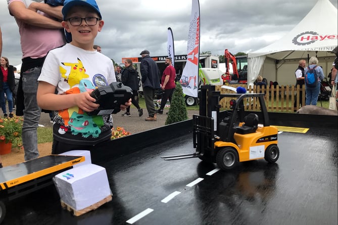 Mini forklifts on trade stand pull in young fans- Charlie Nicholas of Liskeard on West Exe Forklifts stand