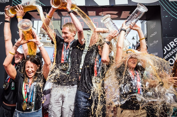COOLING OFF: Donald Brooks, third from left, and his fellow podium finishers give themselves a beer shower.