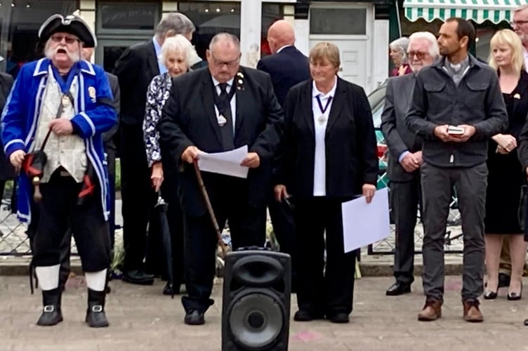 Mayor of Teignmouth Iain Palmer reads the Royal proclamation. Photo courtesy of Voyage Art Gallery