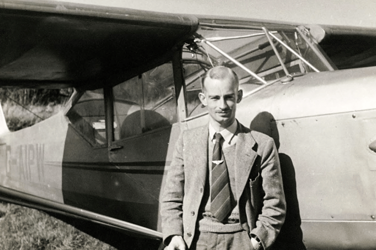 Harold Wingham standing beside an Auster 5J-160 light aircraft built in 1946.
