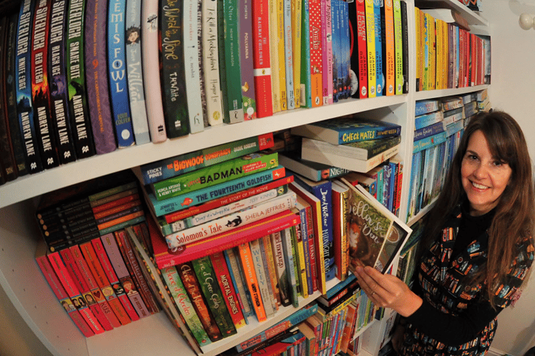Linda Robson-Burrell and some of the books in her store room.