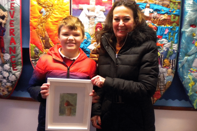 MP Anne Marie Morris congratulates Josh Jenkinson on winning the competition to design her a Christmas card.
