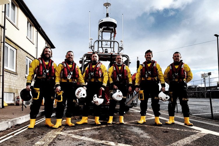 RNLI Teignmouth volunteers congratulate Mark Annal (far right) on passing his Helm Assessment. 