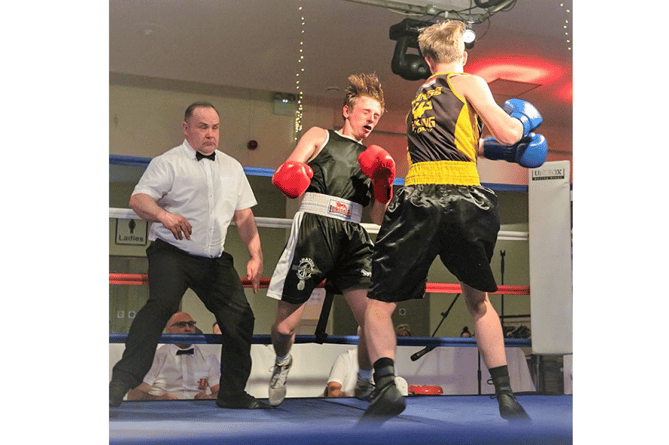 Kingsteignton-based Kings Boxing Academy’s Finn Addiscott (right) throws a left hook at his opponenet during a bout in Weymouth in January.