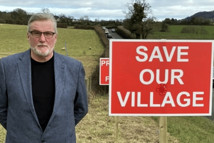Cllr Andrew MacGregor at the site of the proposed homes near Bishopsteignton.
