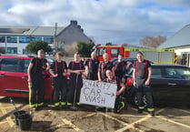Firefighters raise more than £1,000 at charity wash