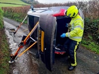 Couple and a dog rescued from overturned car