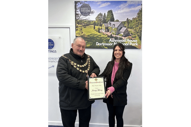 Teignmouth mayor, Cllr Iain Palmer, presents community champion, Jennay Murray, with her award