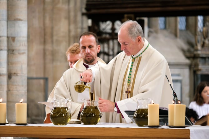 The Bishop of Exeter, right, and Bishop of Plymouth preparing holy oils to be blessed.