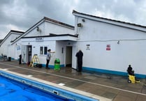 Volunteers see pool is spick and span ahead of Saturday's opening 