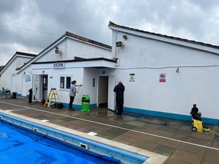 Volunteers see pool is spick and span ahead of Saturday's opening 
