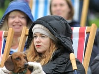 Revellers brave wet weather to watch Coronation at Powderham Castle
