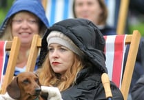 Revellers brave wet weather to watch Coronation at Powderham Castle
