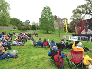 Crowds at Powderham Castle watch the coronation of King Charles III