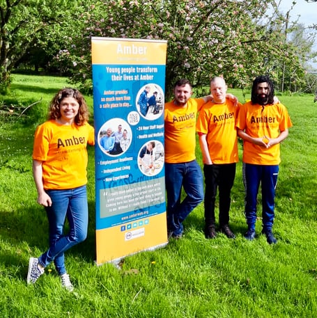 Becky Fry, Fundraising Manager along with three young people from Amber. Kian, Byron and Shakeil.
