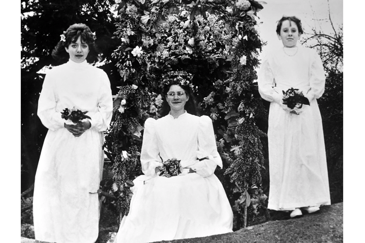 Lustleigh May Day from 1986. Above are May Queen Carolyn Tapson (seated) with attendants Tonya Lee ( left) and Sally Ann Lilley (right) , while the photograph below shows the parade making its way through the village.