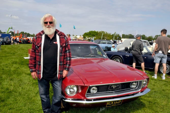 Colin Banks with his candy apple red Ford Mustang. 