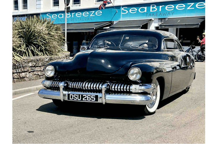 Classic cars drive through Dawlish