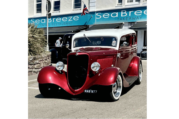Classic cars drive through Dawlish