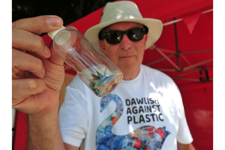 Steve Templemen from Dawlsih Against Plastic with a phial of plastic nurdles.