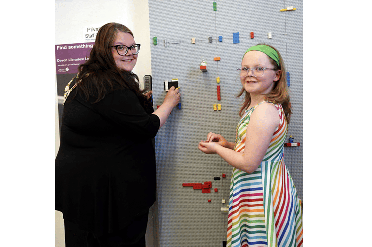 Dawlish mayor, Cllr Rosie Dawson, and her daughter Kitty try out the new Lego wall.