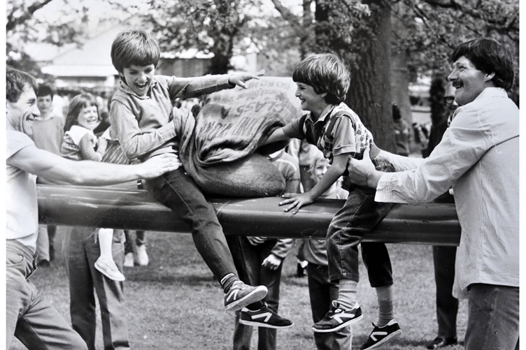 Samual Whitehead battles his younger brother Paul Whitehead with pillows on the greasy pole.