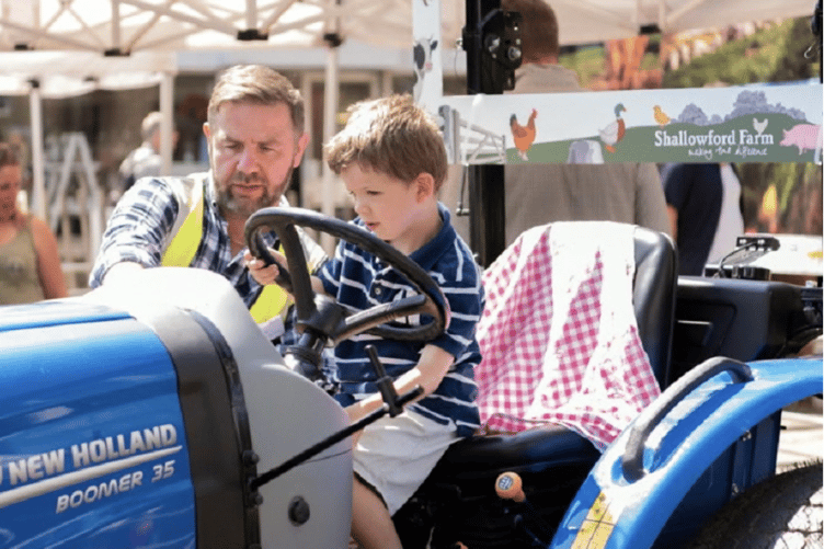 Not your average London runabout - one youngster gets to grips with a tractor.