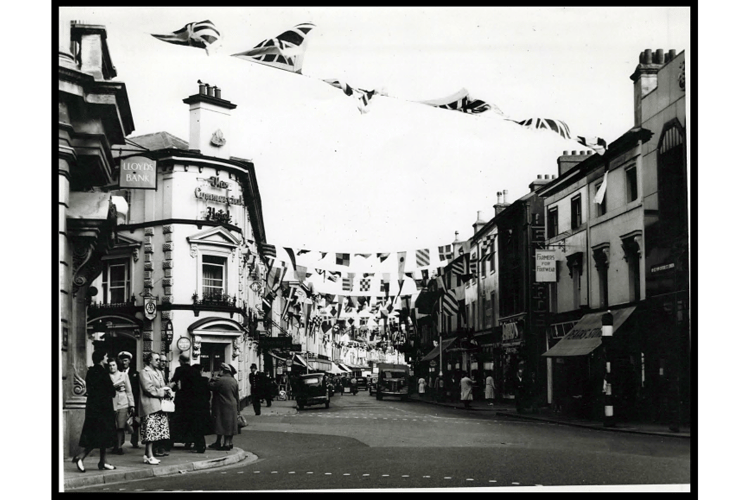 Queen Street with the Commercial Hotel on left, and the street decorated with bunting.