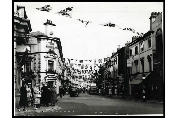 Queen Street with the Commercial Hotel on left, and the street decorated with bunting.