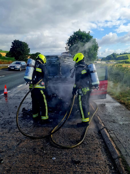 Firefighters battle car fire on. A38 today