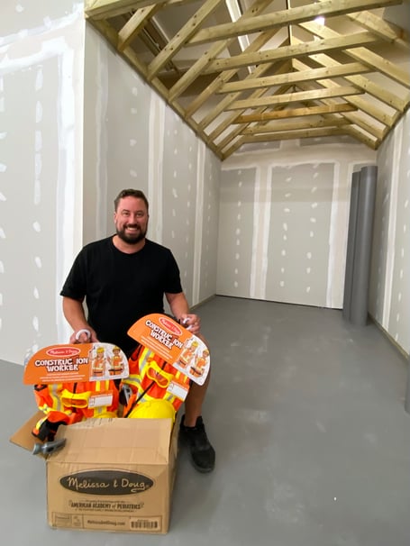 Rhys Heavens starting to unpack play equipment as iTown Newton Abbot takes shape.
Picture: NATC (11-7-23)