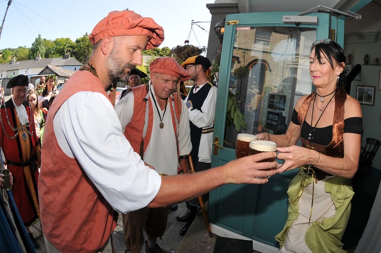 Photo: Steve Pope MDA160722C_SP007
Ashburton Ale Tasting and Bread Weighing Ceremony. Ale tasters Nick Laity and Tony Lewis take the ale to be proved from Julie Scibilia of The Silent Whistle