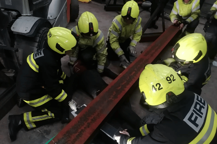 Bovey Tracey spent their drill night at Centristic in Heathfield for a simulated entrapment exercise on Tuesday. The first crew in attendance were faced with a forklift driver who had suffered a medical episode while moving a steel beam which had crushed 2 workers and sheared an electrical cable. Crews got to work by committing a BA team due to a possible Hazardous Materials incident before discovering the damaged electrical cable which was conducting an electrical current through the beam and other pieces of equipment. Using electrical gloves, the team were able to isolate the premises and make the vehicle safe. Once the area area was confirmed safe to work in, another crew were deployed to rescue the casualties. Using Stabilisation Equipment and airbags, the crews were able to raise the beam enough to carry out rescues on the staff while a snatch rescue was performed on the fork lift driver.