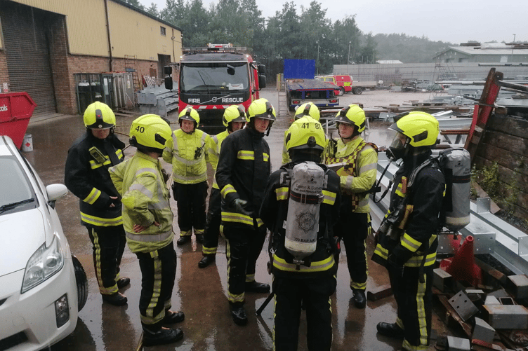 Bovey Tracey spent their drill night at Centristic in Heathfield for a simulated entrapment exercise on Tuesday. The first crew in attendance were faced with a forklift driver who had suffered a medical episode while moving a steel beam which had crushed 2 workers and sheared an electrical cable. Crews got to work by committing a BA team due to a possible Hazardous Materials incident before discovering the damaged electrical cable which was conducting an electrical current through the beam and other pieces of equipment. Using electrical gloves, the team were able to isolate the premises and make the vehicle safe. Once the area area was confirmed safe to work in, another crew were deployed to rescue the casualties.  Using Stabilisation Equipment and airbags, the crews were able to raise the beam enough to carry out rescues on the staff while a snatch rescue was performed on the fork lift driver.
