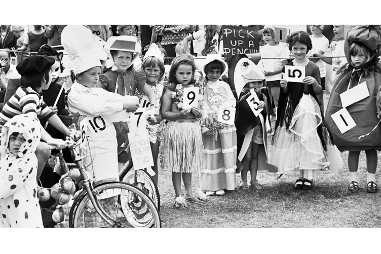 Numbers at the ready participants in the fancy dress competition await the judges.
