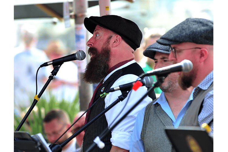 The Rusty Tubs entertain the crowds with songs from the sea.