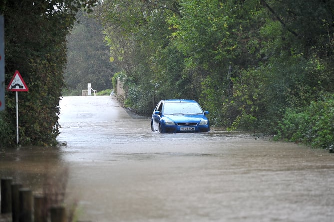 Flooding at Teigngrace near Newton Abbot. Abandonded vehicle in flood water