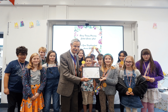 Bovey Primary School Garden Club members receive their award from Mark Bailey.
