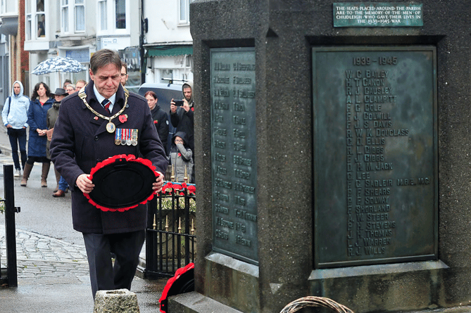 Mayor  of Chudleigh Cllr Rick Webb lays a wreath at the town’s  war memorial.