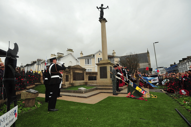 Standards are lowered as the last post is  played at Newton  Abbot’s war memorial.
