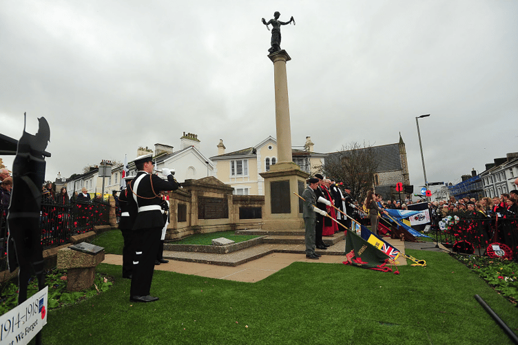Standards are lowered as the last post is played at Newton Abbot’s war memorial.