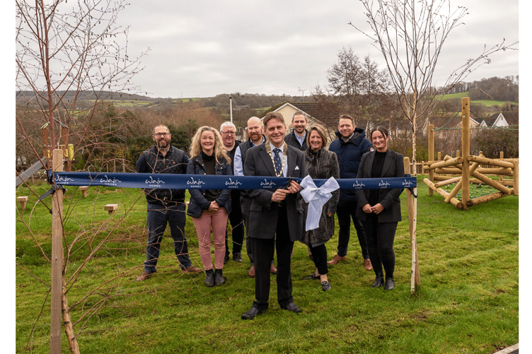 Cllr Richard Webb cuts the ribbon to open the play area at The Leighs
development in Chudleigh