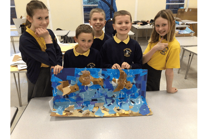 Proud pupils with some of the art work they
created at the workshop.