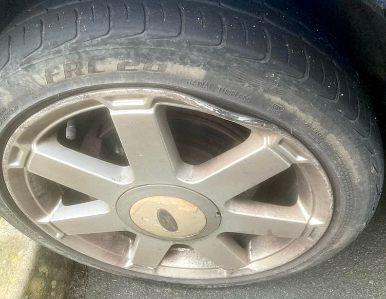 A wheel rim damaged by a pothole