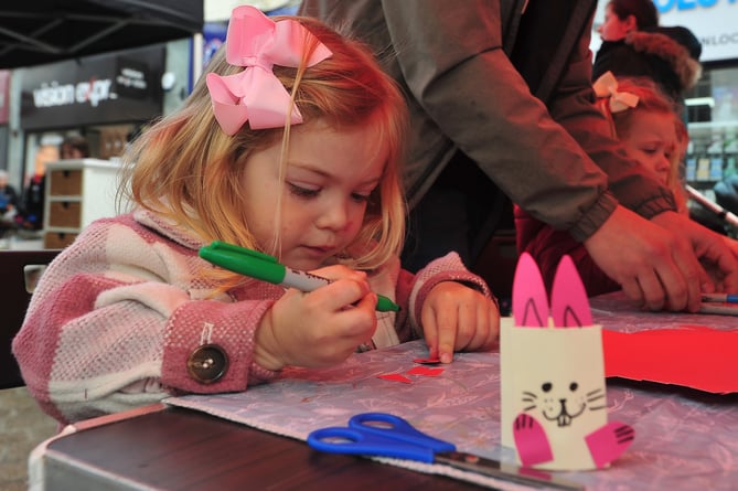 Free Easter-themed fun in Newton Abbot's Courtnenay Street.   Two-and-a-half year old Darcey Mae Jennings from Newton Abbot gets crafting courtesy of Creative Newton Abbot