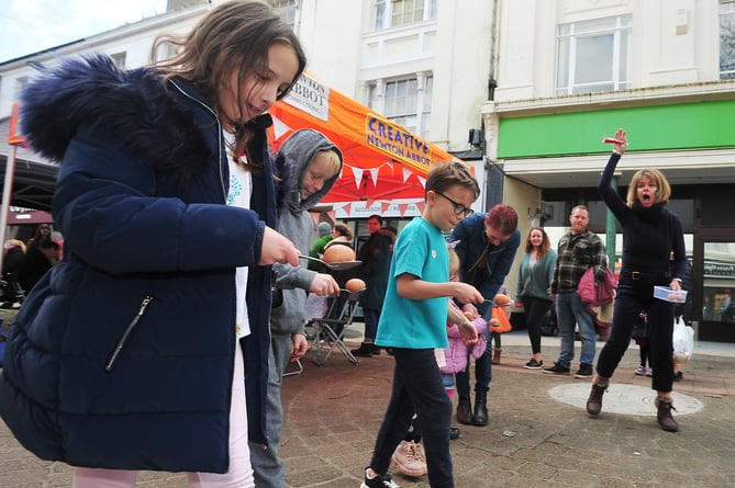 Free Easter-themed fun in Newton Abbot's Courtnenay Street.   Start of the youngster's egg and spoon race